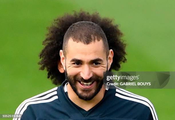 Real Madrid's French forward Karim Benzema and Real Madrid's Brazilian defender Marcelo attend a training session at the Valdebebas training ground...