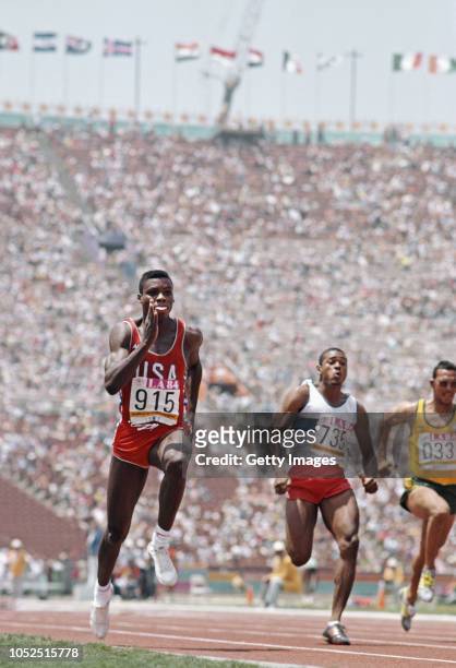 Sprinter Carl Lewis in action during the Mens 100 Metres Heats with Peter Van Miltenburg of Australia at the Los Angeles Memorial Coliseum on August...