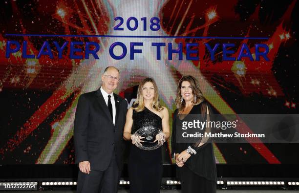 Simona Halep of Romania poses on stage with her Player of the Year award with Jennifer Capriati and Steve Simon , CEO and Chairman of the WTA during...