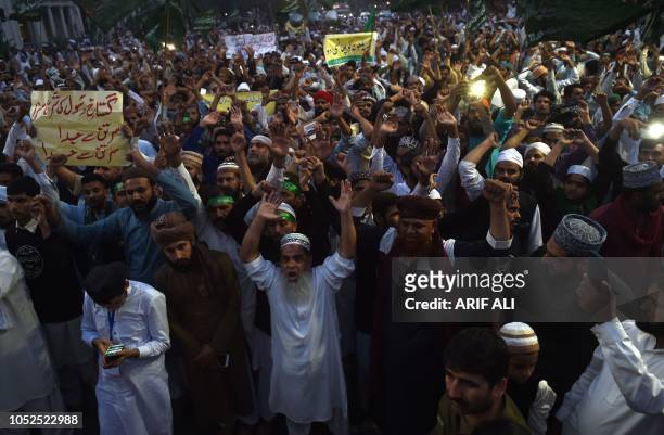 Supporters of Tehreek-e-Labaik Ya Rasool Allah, a hardline religious party, chant slogans as they march during a protest in Lahore on October 19...