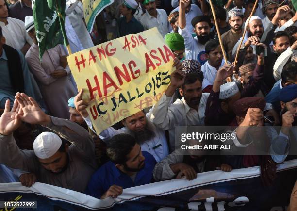 Supporters of Tehreek-e-Labaik Ya Rasool Allah, a hardline religious party, march during a protest in Lahore on October 19 demanding for hanging to a...