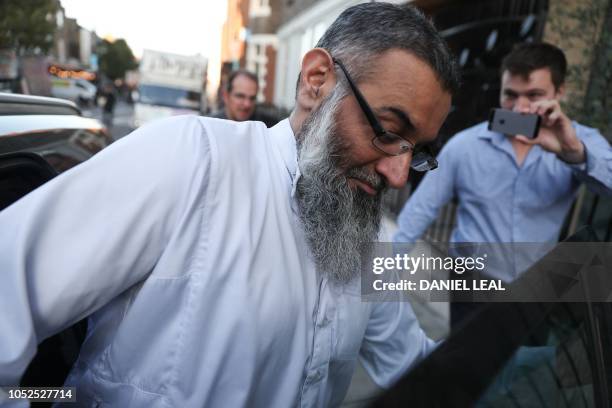 Radical cleric Anjem Choudary is seen getting into a vehicle leaving a probation hostel in London on October 19, 2018 following his release from...