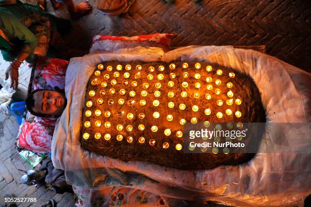 Nepalese devotee hold oil lamps on their body during the tenth day of Dashain Durga Puja Festival in Bramayani Temple, Bhaktapur, Nepal on Friday,...