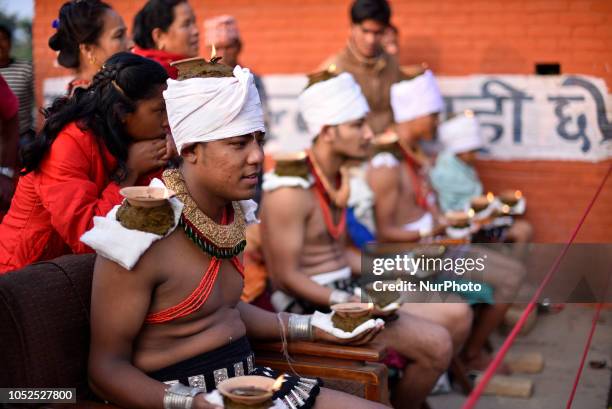 Nepalese devotees hold oil lamps on their body during the tenth day of Dashain Durga Puja Festival in Bramayani Temple, Bhaktapur, Nepal on Friday,...