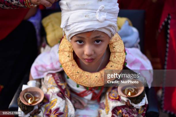 Little kid hold oil lamps on his body during the tenth day of Dashain Durga Puja Festival in Bramayani Temple, Bhaktapur, Nepal on Friday, October...