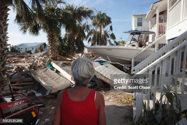 LeClaire Bryan, mother of country music artist Luke Bryan, looks over debris piled near her home by Hurricane Michael on October 19, 2018 in Mexico...