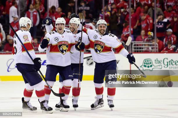 Jonathan Huberdeau of the Florida Panthers celebrates with his teammates after scoring the game winning goal during a shootout against the Washington...