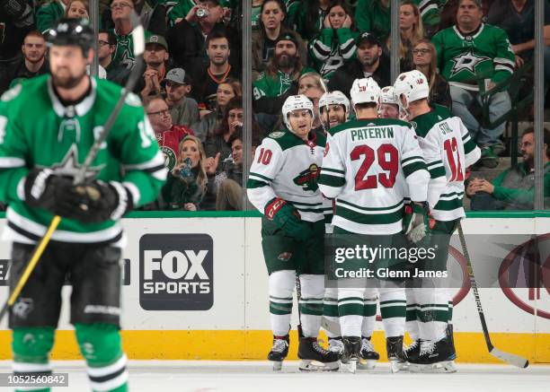 Greg Pateryn, Matt Read, Eric Staal and the Minnesota Wild celebrate a goal against the Dallas Stars at the American Airlines Center on October 19,...