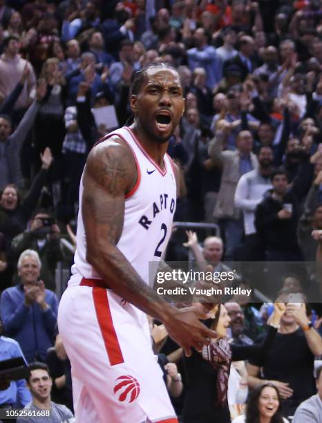 Kawhi Leonard of the Toronto Raptors reacts after sinking a basket during the second half of an NBA game against the Boston Celtics at Scotiabank...