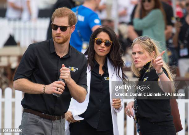 The Duke and Duchess of Sussex with the Duchess's Private Assistant Secretary Amy Pickerill at the Invictus Games Jaguar Land Rover Driving...