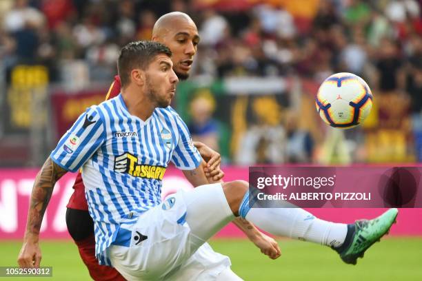 S Italian forward Alberto Paloschi and AS Rome's French midfielder Steven Nzonzi go for the ball during the Italian Serie A football match AS Roma vs...