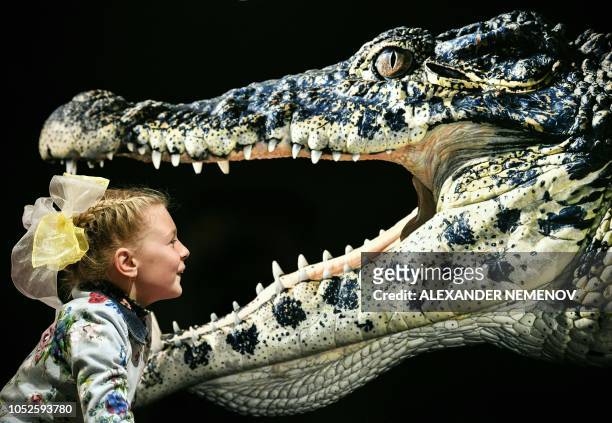 Young visitor looks at the photograph 'Cuban Crocodile' by Tim Flach, a British photographer who specialises in studio photography of animals, during...