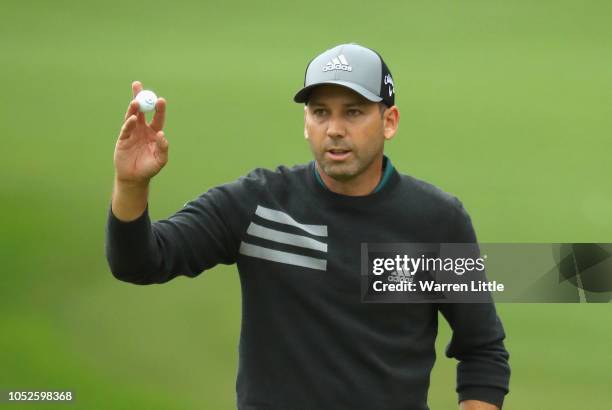 Sergio Garcia of Spain acknowledges the crowd on the 18th green during the completion of the weather affected second round of the Andalucia...