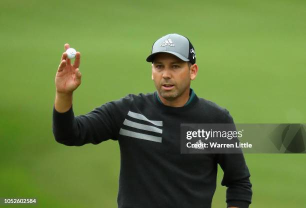 Sergio Garcia of Spain acknowledges the crowd on the 18th green during the completion of the weather affected second round of the Andalucia...