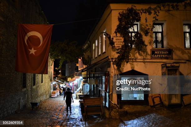 Person walks under the Turkish national flag in Safranbolu town in the northern city of Karabuk, Turkey on October 20, 2018. Safranbolu had become a...
