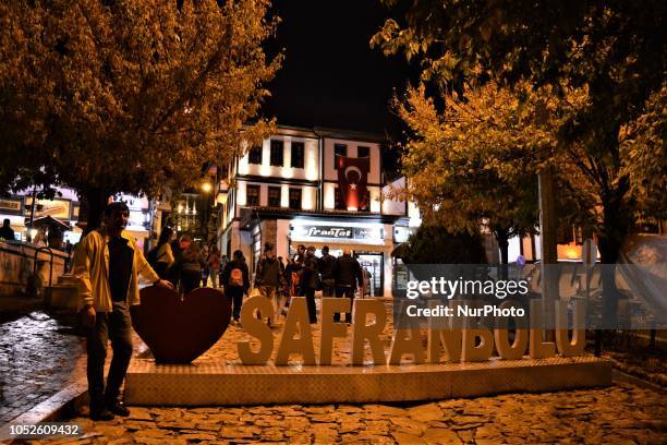 Tourist poses in front of a sign in Safranbolu town in the northern city of Karabuk, Turkey on October 20, 2018. Safranbolu had become a UNESCO World...