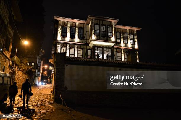 People walk past a traditional house in Safranbolu town in the northern city of Karabuk, Turkey on October 20, 2018. Safranbolu had become a UNESCO...
