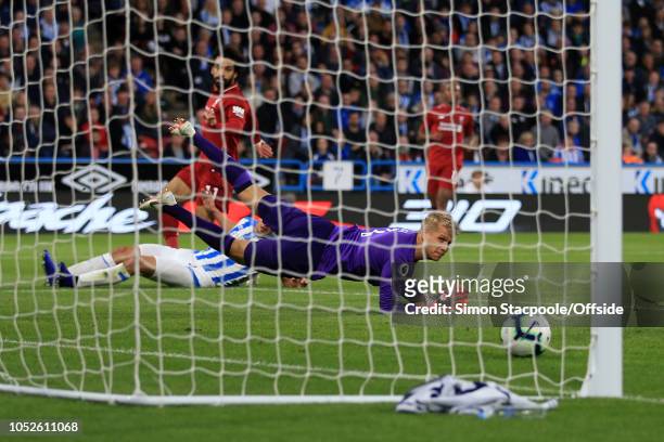 Huddersfield goalkeeper Jonas Lossl looks back helplessly as Mohamed Salah of Liverpool scores their 1st goal during the Premier League match between...