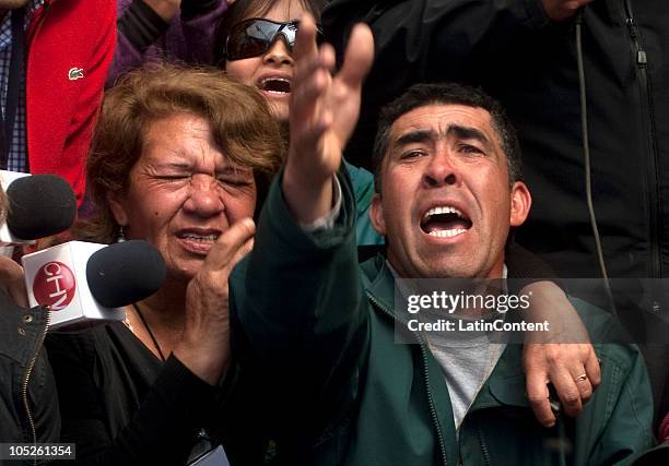 Relatives of one of the 33 miners trapped in San Jose mine weep as they await for them to come up to the surface during the rescue operation of 33...