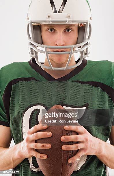 teen boy in football gear, portrait - football helmet bildbanksfoton och bilder