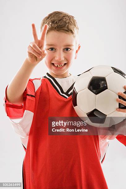 young boy holding soccer ball, portrait - kid middle finger imagens e fotografias de stock