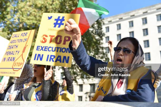 People protest against the death penalty in Iran opposite Downing Street as a march to demand a people's vote against Brexit passes by on October 20,...