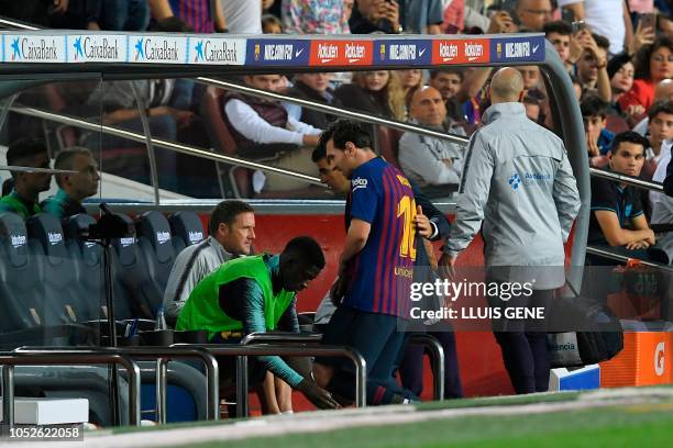 Barcelona's Argentinian forward Lionel Messi leaves the field after sustaining an injury during the Spanish league football match FC Barcelona...