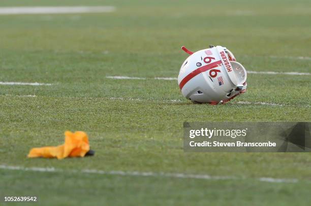 The helmet of a player from the Nebraska Cornhuskers sits on the field after a penalty flag is thrown in the game against the Minnesota Golden...