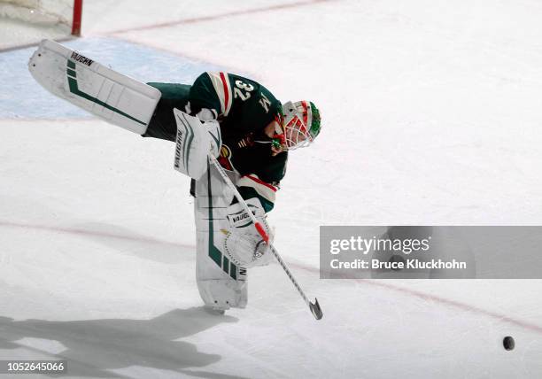 Alex Stalock of the Minnesota Wild plays the puck during a game between the Minnesota Wild and Tampa Bay Lightning at Xcel Energy Center on October...