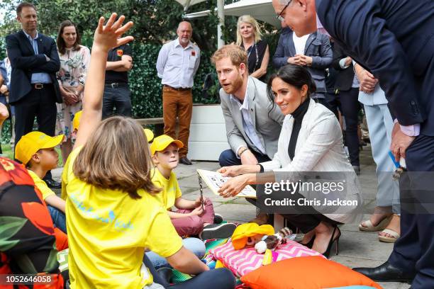 Scott Morrison, Prince Harry, Duke of Sussex and Meghan, Duchess of Sussex talking with young kids during day two of the Invictus Games Sydney 2018...