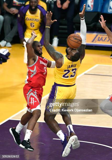 LeBron James of the Los Angeles Lakers is fouled by Chris Paul of the Houston Rockets during the first half at Staples Center on October 20, 2018 in...