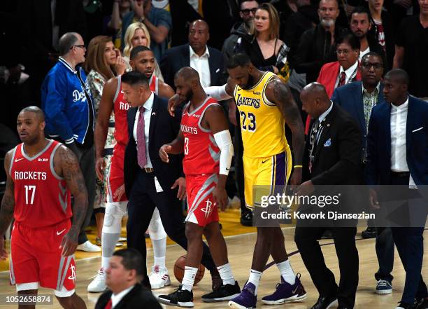 LeBron James of the Los Angeles Lakers hugs Chris Paul of the Houston Rockets after he was ejected for fighting during the second half of a...