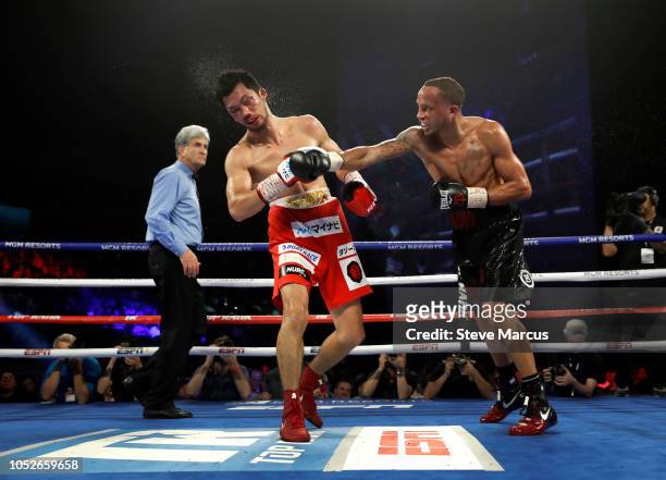 Middleweight champion Ryota Murata of Japan is hit with a punch from Rob Brant of the U.S. As referee Vic Drakulich looks on during the 12th round of...