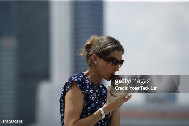 Legend Monica Seles enjoys fresh Coconut juice and poses for a photo at the Courtside by the Bay at Marina Bay Sands on October 21, 2018 in Singapore.