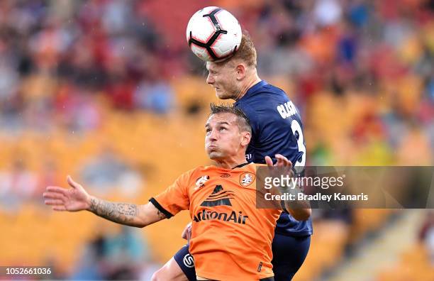 Jack Clisby of the Mariners gets above Eric Bautheac of the Roar as they challenge for the ball during the round one A-League match between the...