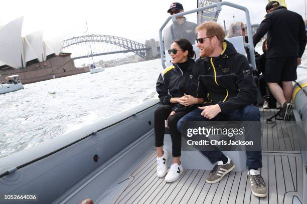 Prince Harry, Duke of Sussex and Meghan, Duchess of Sussex on Sydney Harbour looking out at Sydney Opera House and Sydney Harbour Bridge during day...