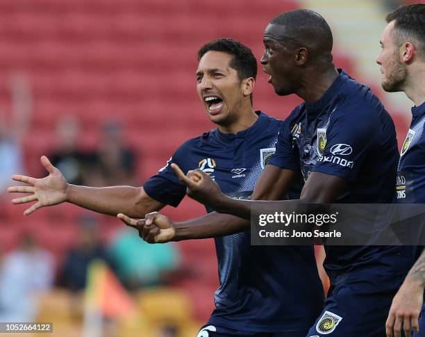 Tom Hiariej of the Mariners and team mate Kalifa Cisse plead with a referee decision during the round one A-League match between the Brisbane Roar...