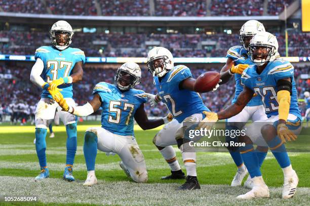 Denzel Perryman of Los Angeles Chargers celebrates his interseption with teammates during the NFL International Series match between Tennessee Titans...