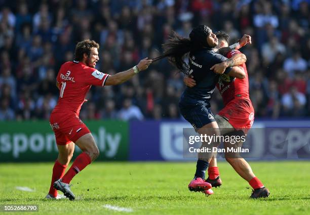 Joseph Tomane of Leinster is tackled by Maxime Medard and Sofiane Guitoune of Toulouse during the Champions Cup match between Toulouse and Leinster...