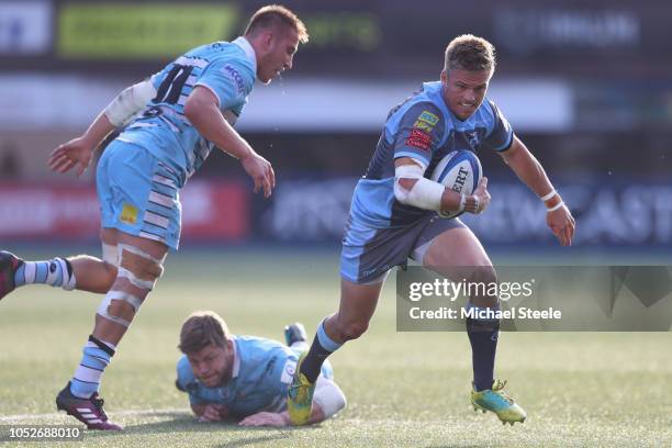 Gareth Anscombe of Cardiff evades the challenge of Matt Ferguson of Glasgow during the Champions Cup Pool 3 match between Cardiff Blues and Glasgow...