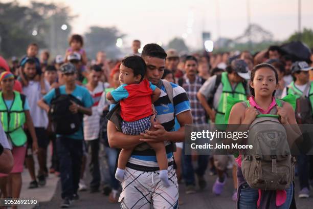 Members of a migrant caravan walk into the interior of Mexico after crossing the Guatemalan border on October 21, 2018 near Ciudad Hidalgo, Mexico...