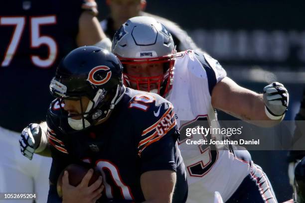 Lawrence Guy of the New England Patriots tackles quarterback Mitchell Trubisky of the Chicago Bears in the first quarter at Soldier Field on October...