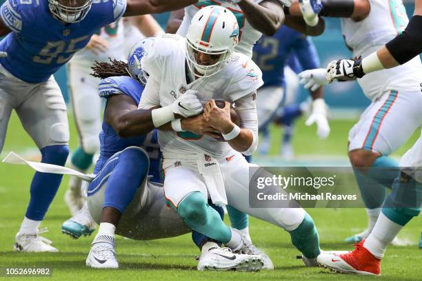 Ricky Jean Francois of the Detroit Lions sacks Brock Osweiler of the Miami Dolphins during the first half at Hard Rock Stadium on October 21, 2018 in...