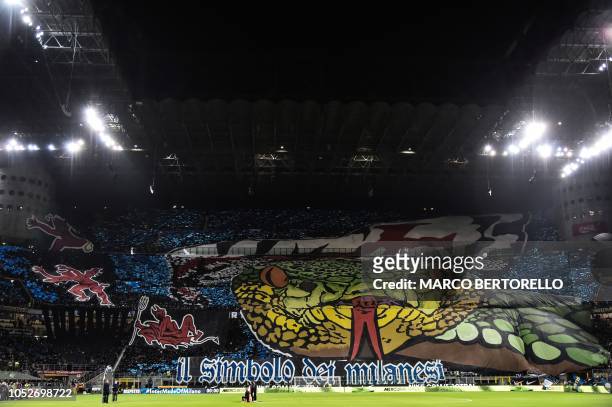 Milan fans unfurl giant tifos prior to the Italian Serie A football match Inter Milan vs AC Milan on October 21, 2018 at the San Siro stadium in...
