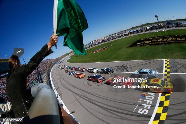 Joey Logano, driver of the Shell Pennzoil Ford, and Kevin Harvick, driver of the Busch Light Ford, lead the field at the start of the Monster Energy...