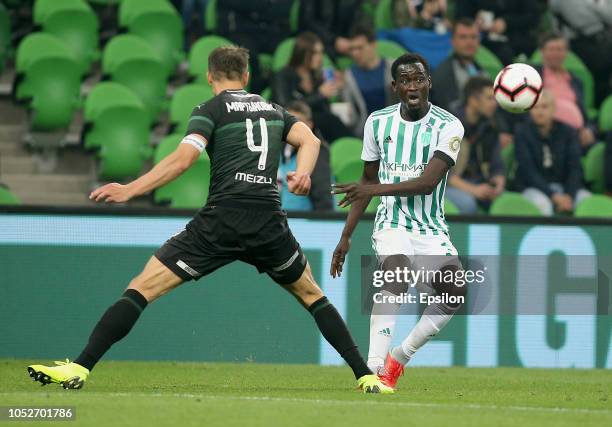 Alyaksandr Martynovich of FC Krasnodar vies for the ball with Ablaye Mbengue of FC Akhmat Grozny during the Russian Premier League match between FC...