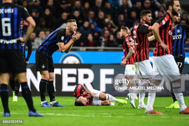Inter Milan's Slovak defender Milan Skriniar reacts after fouling AC Milan's Spanish forward Suso during the Italian Serie A football match Inter...