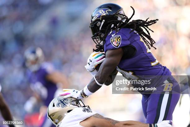 Running Back Alex Collins of the Baltimore Ravens carries the ball in the first quarter against the New Orleans Saints at M&T Bank Stadium on October...