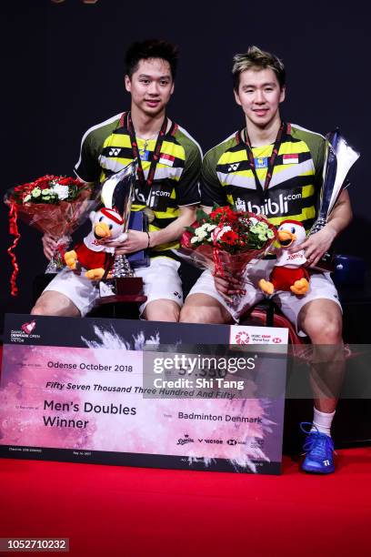 Marcus Fernaldi Gideon and Kevin Sanjaya Sukamuljo of Indonesia pose with their trophies after the Men's Double final match against Takeshi Kamura...