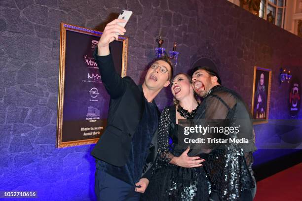 Leonard Freier, his wife Caona Freier and Julian David attend the musical premiere of 'Tanz der Vampire' at Theater des Westens on October 21, 2018...